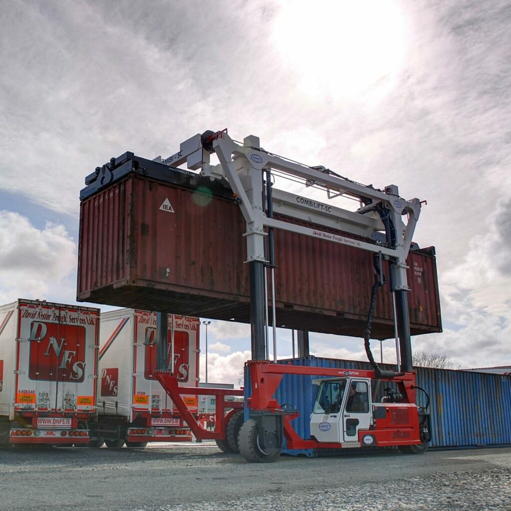 Laden Container Handling & Storage. Container being Lifted onto DFNFS Truck.